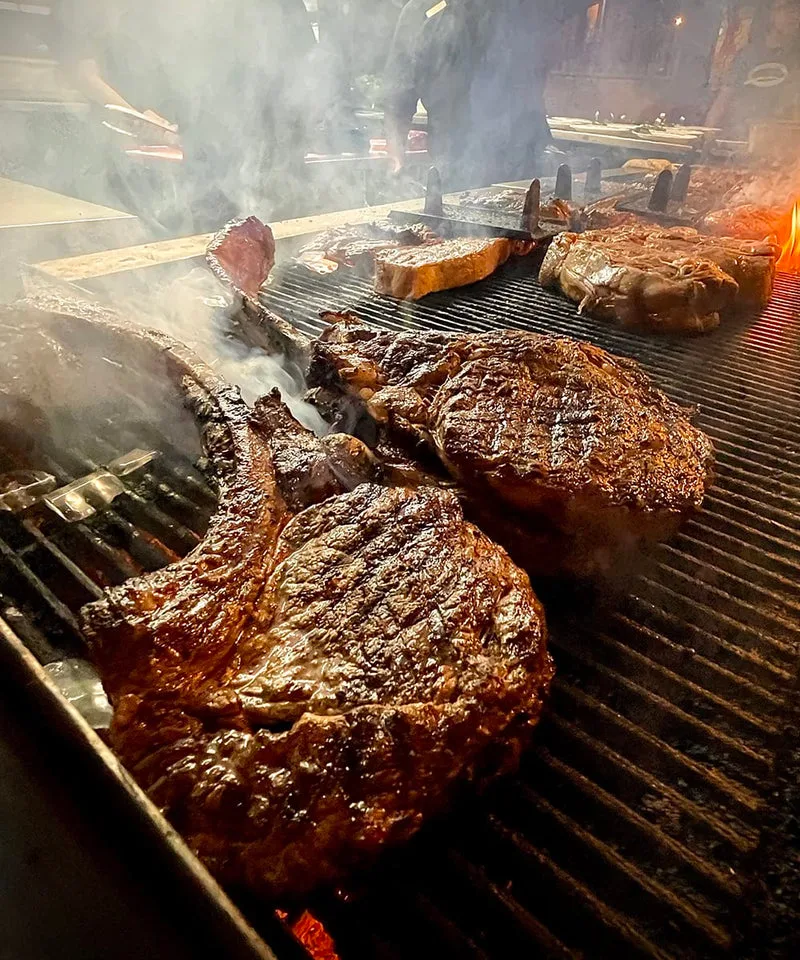 Grilled Big Texan tomahawk steaks prepared for the table